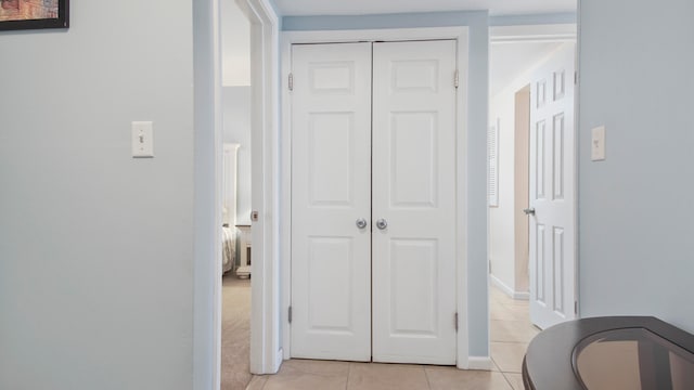 corridor featuring light tile patterned floors