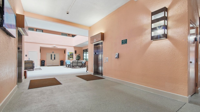 interior space featuring an outdoor hangout area, a patio, and elevator