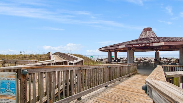 view of dock with a water view and a gazebo