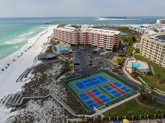 birds eye view of property with a water view and a view of the beach