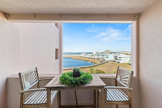 balcony featuring a water view