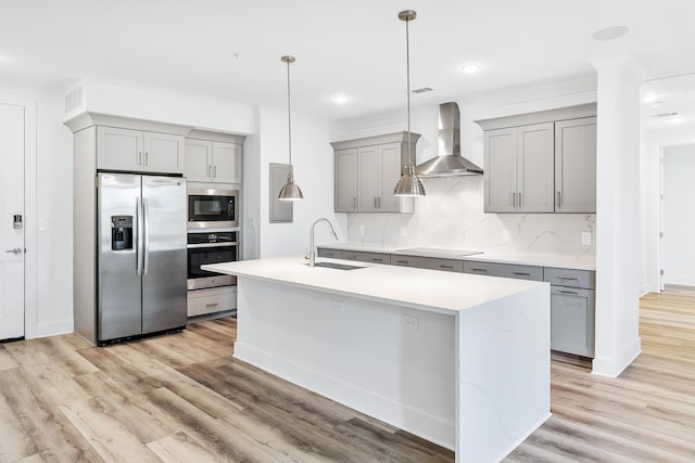 kitchen featuring light hardwood / wood-style flooring, black appliances, backsplash, wall chimney range hood, and sink