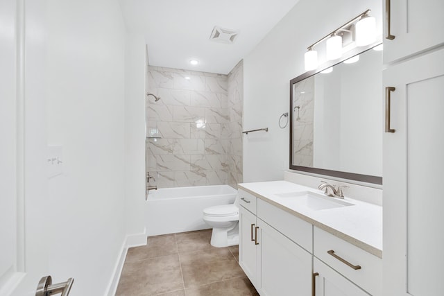 full bathroom with tile floors, tiled shower / bath combo, toilet, and vanity