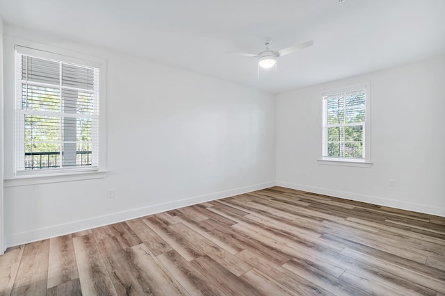 unfurnished room featuring ceiling fan, a healthy amount of sunlight, and light hardwood / wood-style flooring