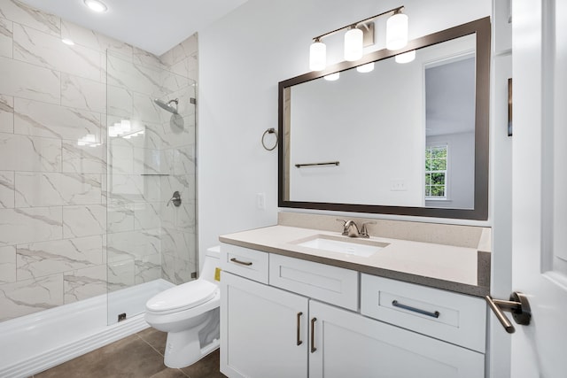 bathroom featuring an enclosed shower, vanity, toilet, and tile floors