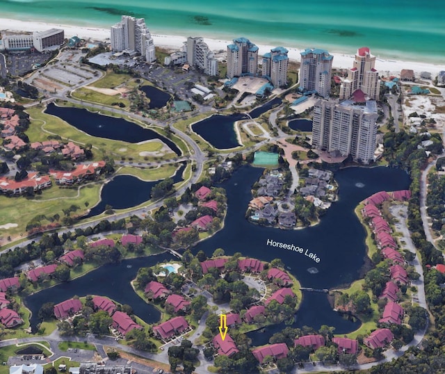 birds eye view of property featuring a view of the beach and a water view