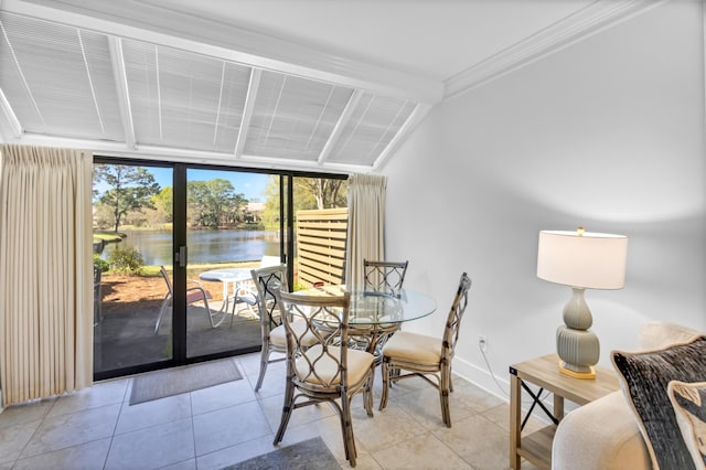 tiled dining area with french doors, lofted ceiling with beams, expansive windows, a water view, and crown molding