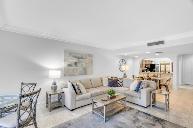 living room featuring ornamental molding and light tile patterned floors