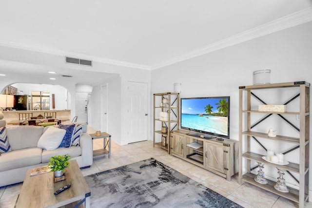 living room with light tile patterned floors and crown molding