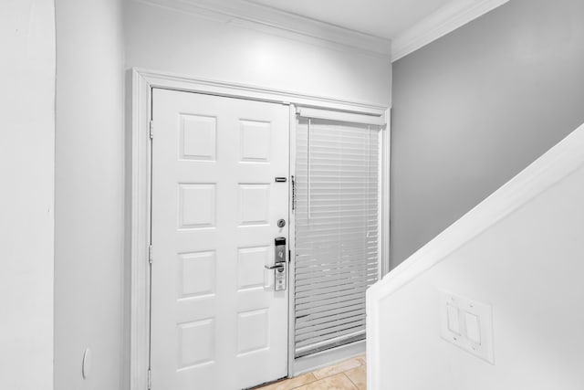 entryway featuring crown molding and light tile patterned floors