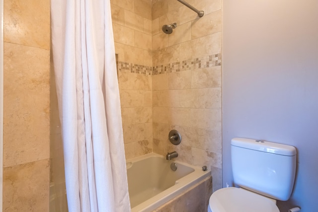 bathroom with toilet and shower / tub combo with curtain