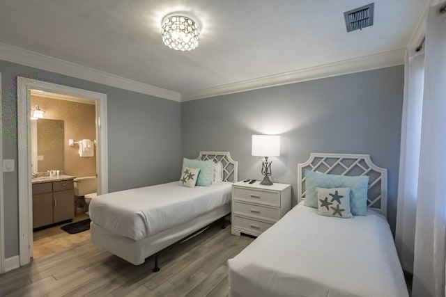 bedroom featuring ensuite bathroom, wood-type flooring, and crown molding