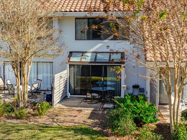 back of house with a patio