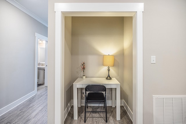 office space with sink, crown molding, and hardwood / wood-style flooring