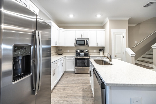 kitchen with white cabinetry, crown molding, light wood-type flooring, stainless steel appliances, and sink