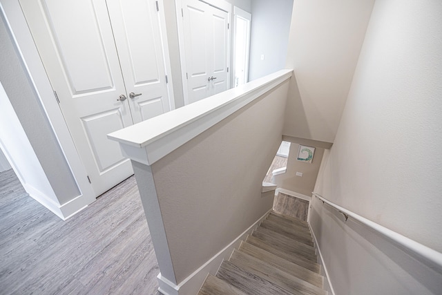 stairs with light hardwood / wood-style floors