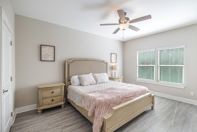 bedroom with wood-type flooring and ceiling fan