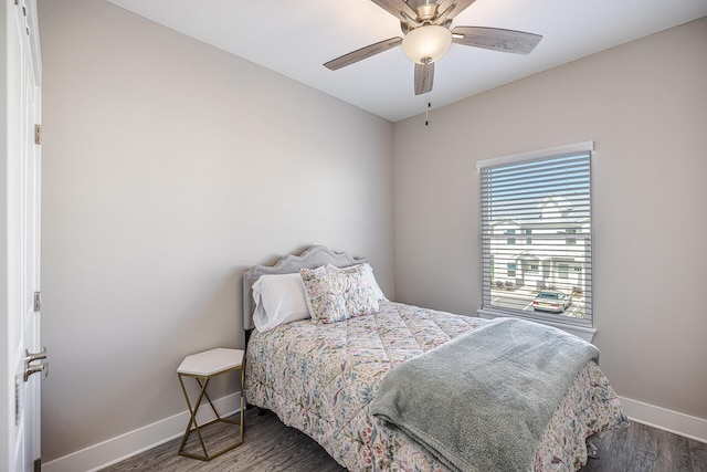 bedroom with ceiling fan and dark hardwood / wood-style flooring