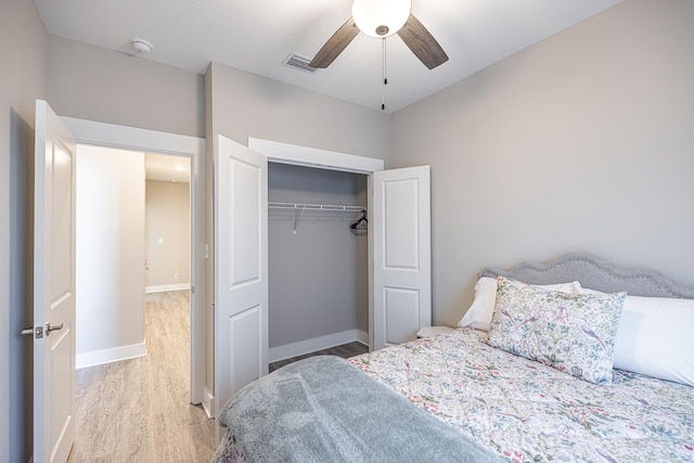 bedroom with light wood-type flooring, a closet, and ceiling fan