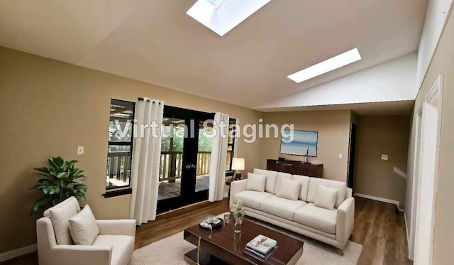 living room featuring hardwood / wood-style floors, vaulted ceiling with skylight, and french doors