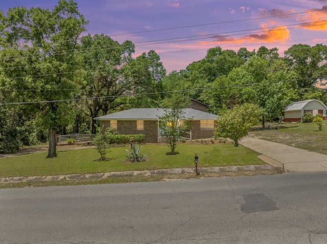 single story home with a yard