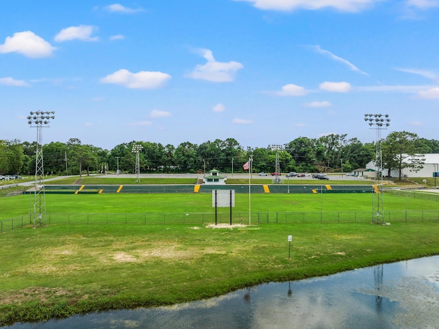 view of community with a lawn and a water view