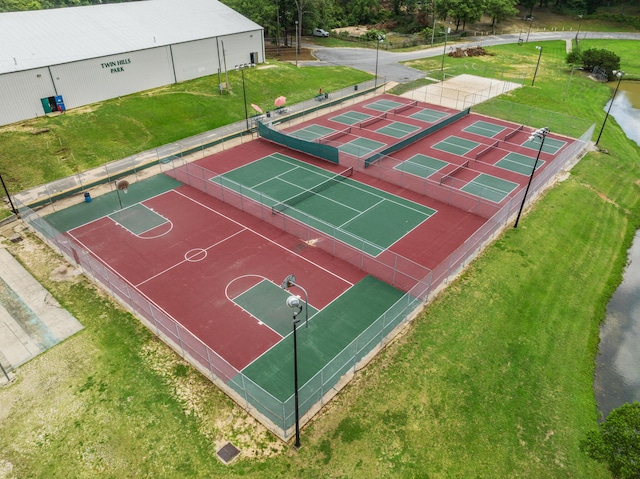 view of sport court featuring a yard