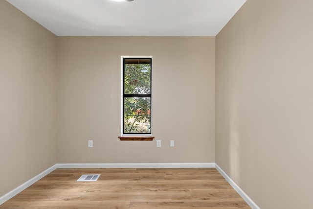 spare room with light hardwood / wood-style flooring