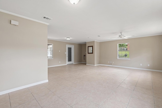 empty room with ornamental molding, ceiling fan, and light tile patterned flooring