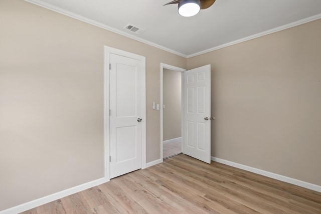 unfurnished room featuring crown molding and light wood-type flooring