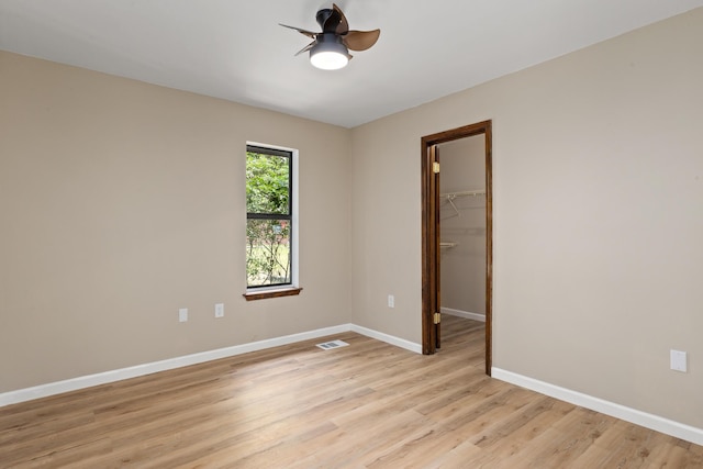 unfurnished room featuring light hardwood / wood-style floors and ceiling fan