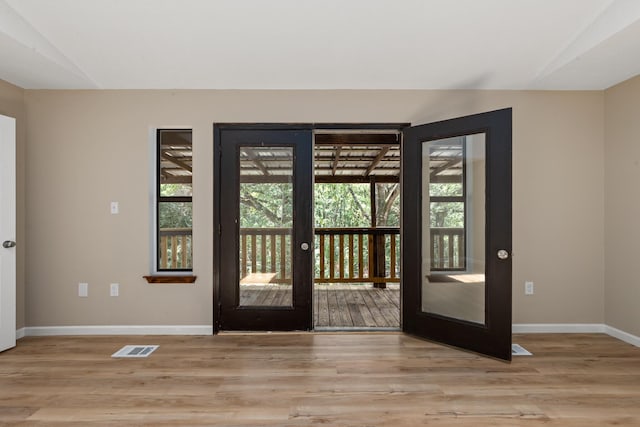 doorway featuring light hardwood / wood-style floors and french doors