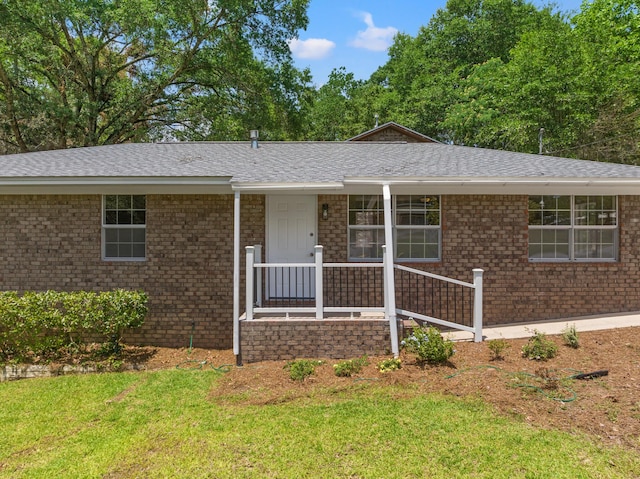 ranch-style home featuring a porch and a front lawn