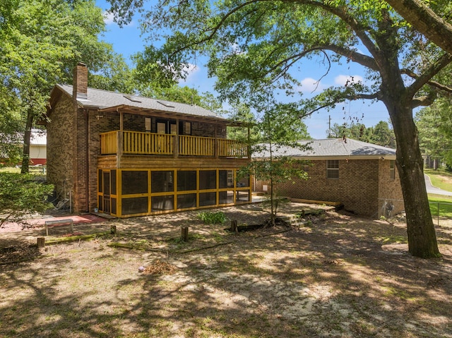 rear view of property with a balcony