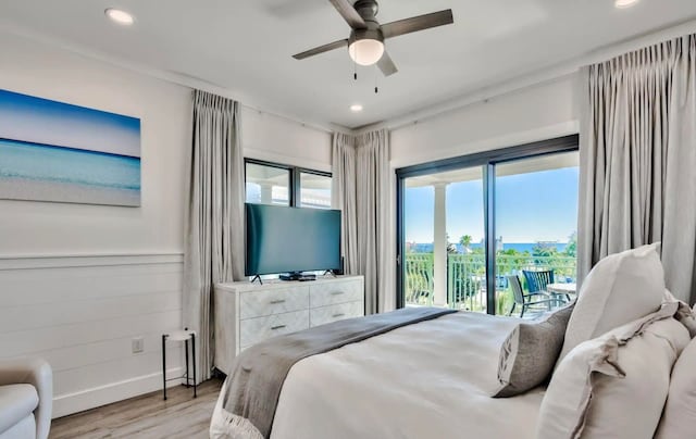 bedroom featuring light hardwood / wood-style flooring, ceiling fan, and access to outside