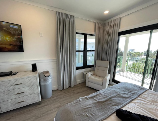 bedroom with wood-type flooring and access to outside