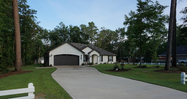 single story home featuring a garage and a front lawn