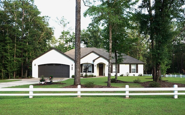 view of front of property with a garage, fence, a front lawn, and concrete driveway