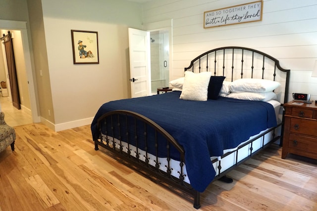 bedroom featuring baseboards and light wood-style floors