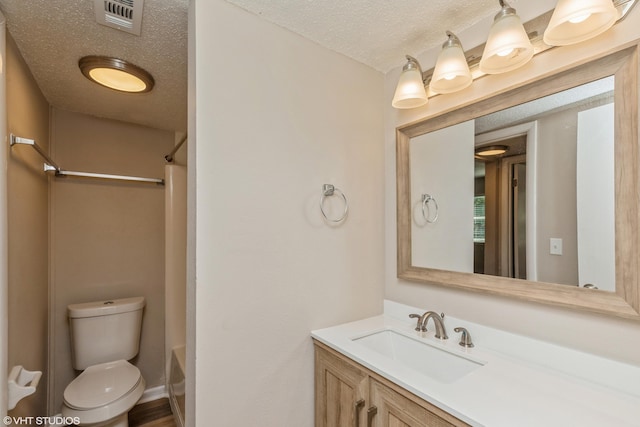 full bathroom featuring vanity, toilet, shower / bath combo with shower curtain, and a textured ceiling