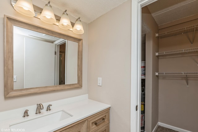 bathroom with vanity and a textured ceiling