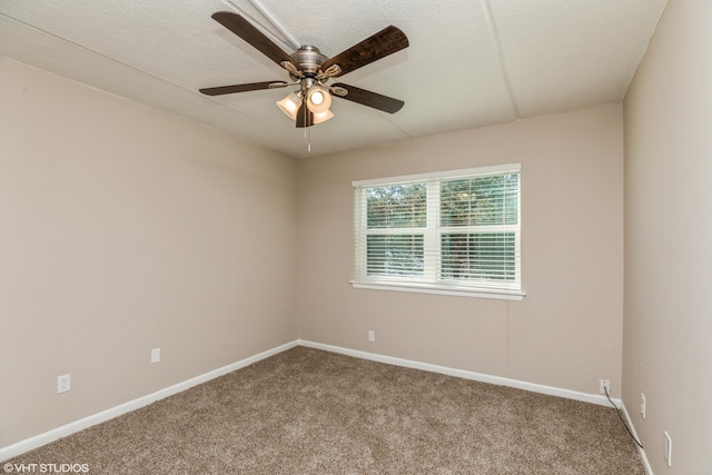 unfurnished room featuring dark carpet and ceiling fan