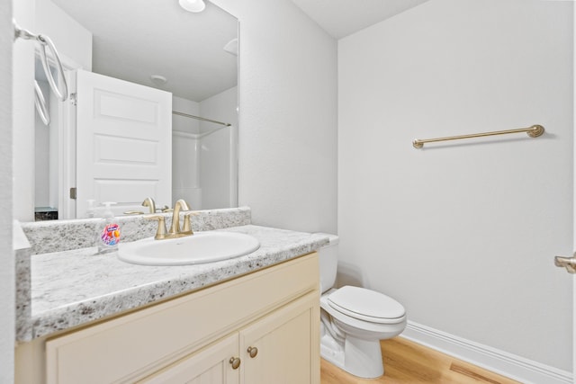 5816 Crestlake Dr, Crestview, FL 32536 - full bathroom featuring vanity, wood finished floors, toilet, baseboards, and a shower