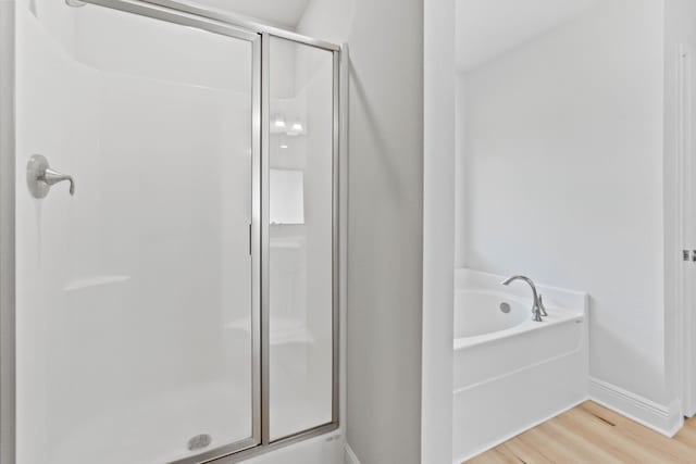 5816 Crestlake Dr, Crestview, FL 32536 - full bath with a stall shower, wood finished floors, a bath, and baseboards