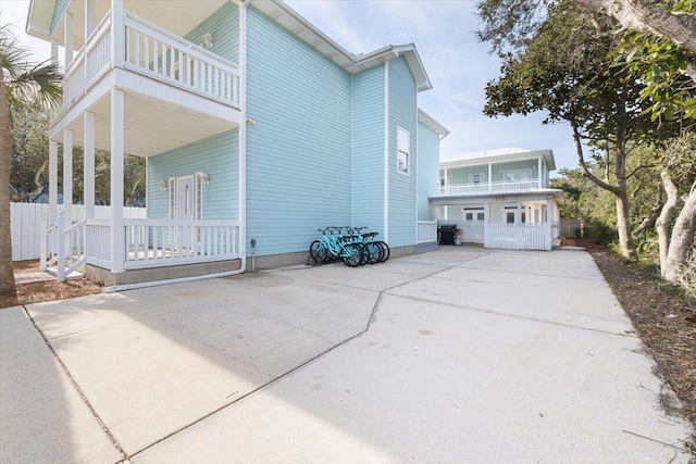 view of home's exterior featuring a balcony and a garage