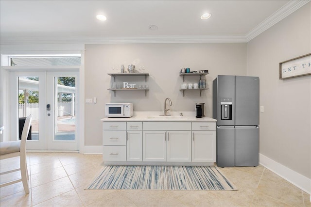 kitchen with stainless steel refrigerator with ice dispenser, french doors, crown molding, sink, and light tile floors