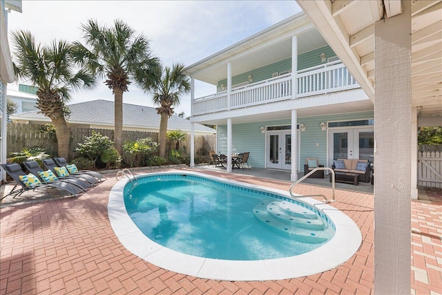 view of swimming pool with a patio area and french doors