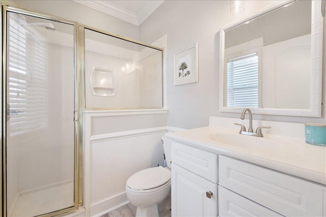 bathroom featuring walk in shower, toilet, vanity with extensive cabinet space, and ornamental molding