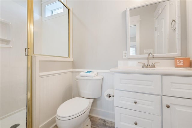 bathroom featuring an enclosed shower, vanity, hardwood / wood-style flooring, and toilet