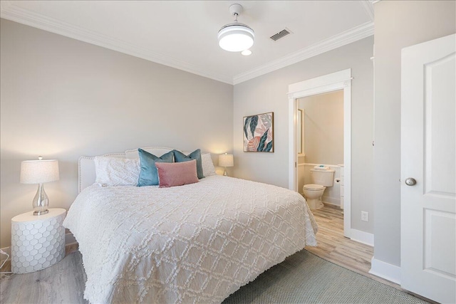 bedroom featuring connected bathroom, ceiling fan, crown molding, and light wood-type flooring